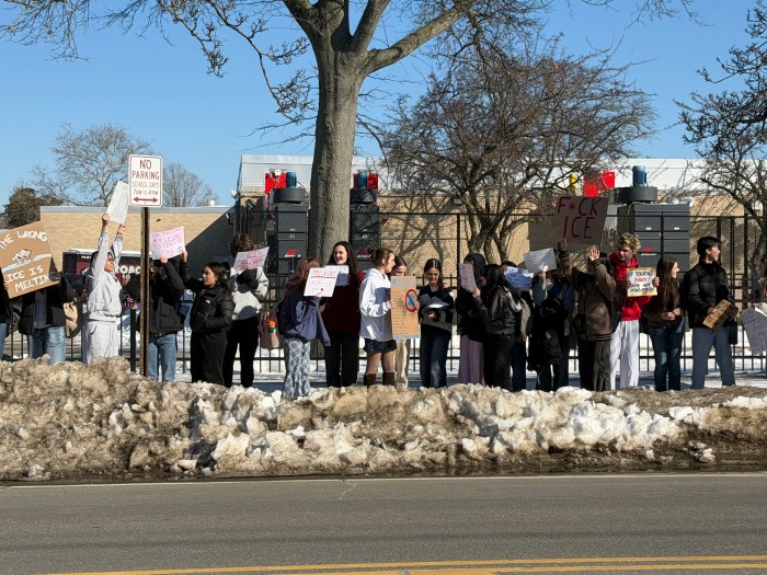 North Shore High School students stood along Glen Cove Avenue chanting. 