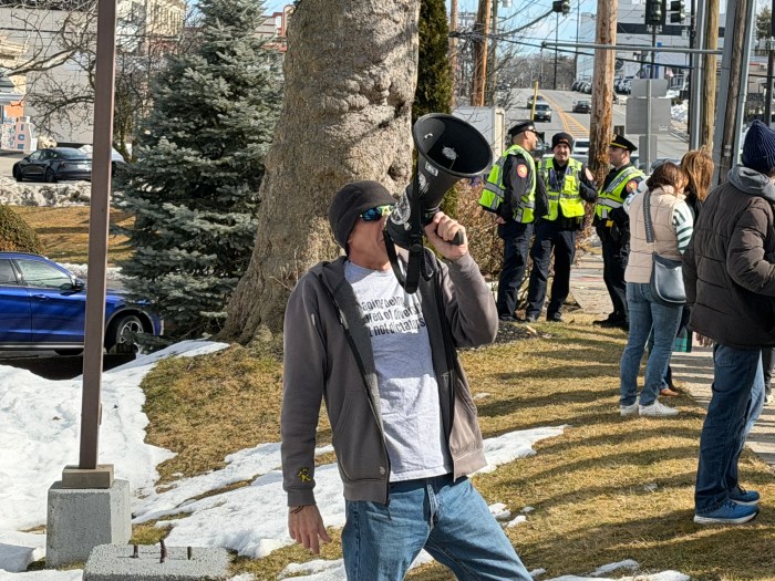 Port Washington resident David Jon Chapman led the group with chants.