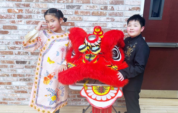 Two children presented to the village board about the Lunar New Year.