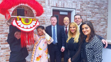 New Hyde Park village officials including Mayor Chris Devane (Center) and village trustees (R.) with child presenters from the village Chinese Association (L.).