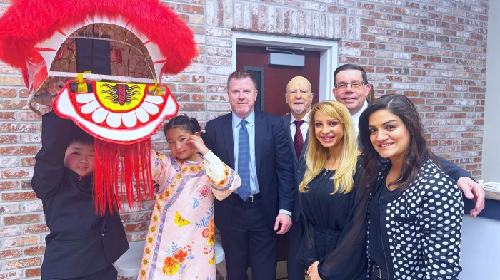 New Hyde Park village officials including Mayor Chris Devane (Center) and village trustees (R.) with child presenters from the village Chinese Association (L.).