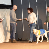 An Old Bethpage couple has trained several puppies through a national organization for service dogs.
