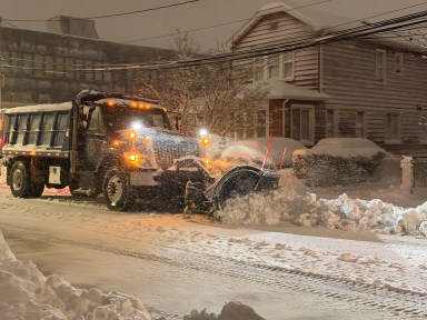 A plow clears a road in New Hyde Park during the Blizzard of 2026. (Long Island Press photo)