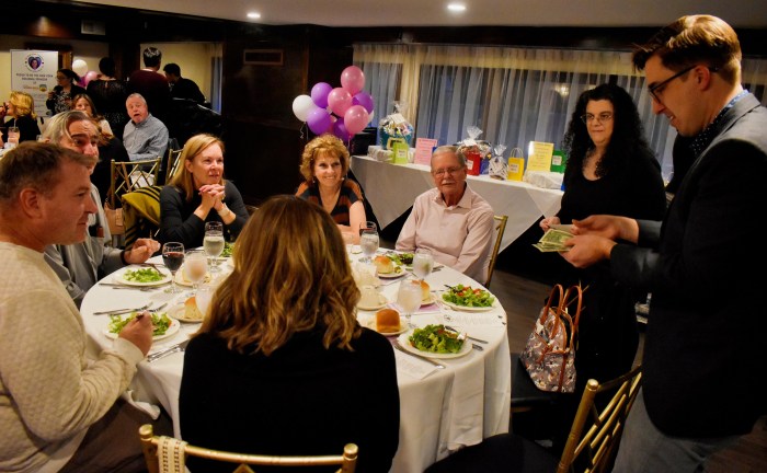 Magician Gary Ferrar performing ‘strolling magic’ at guests’ tables at the 2025 “An Evening of Magic” fundraiser.