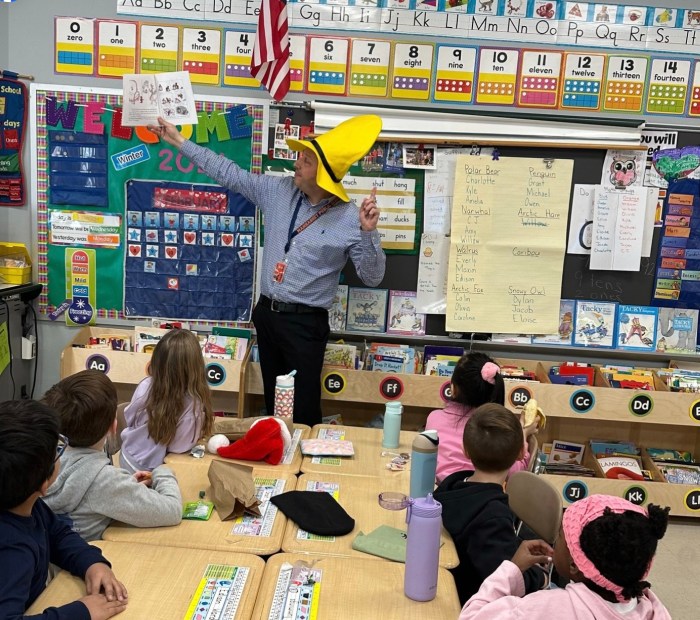 Principal Chad Altman reading to Manhasset students