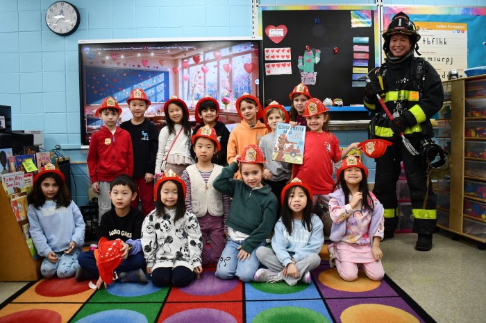 Plandome Firefighter Hin Tsui read "The Gingerbread Man Loose on the Fire Truck"to Shelter Rock first graders.