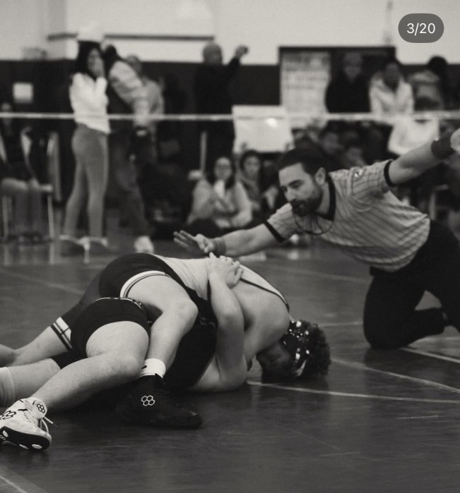High school wrestlers competing at the 2026 Nassau County qualifier tournament hosted by Jericho High School.