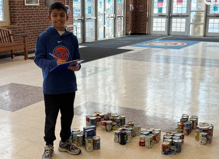 Munsey Park student counting cans for SOUP'er Bowl can drive