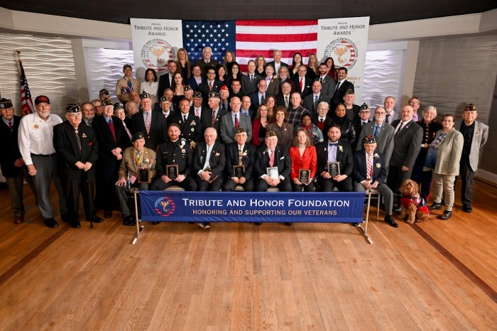 Group photo just prior to the evening’s closing blessing. Seated front and center are the eight honorees. Board members, family members, elected officials, and community leaders gather behind them on the upper platform.