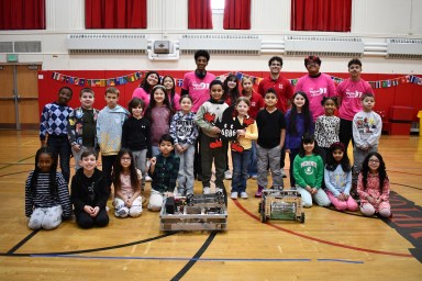 Second graders at Mineola’s Hampton Street School explore coding and robotics during Discovery Day, collaborating with the Mineola High School Robotics Team on hands-on activities and enjoying live robot demonstrations.