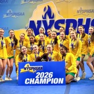 The Varsity squad poses with the 2026 Class A State Championship banner.