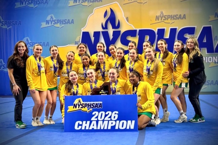 The Varsity squad poses with the 2026 Class A State Championship banner.
