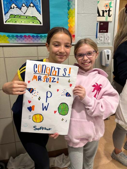 Students surprised Sutz with signs and cheers.