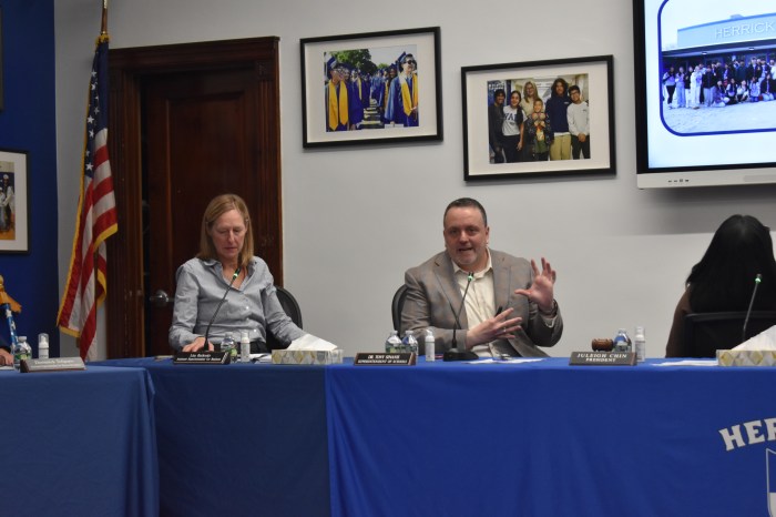 Superintendent Tony Sinanis (R.) and Assistant Superintendent for Business Lisa Rutkoske (L.) at the recent school board meeting.