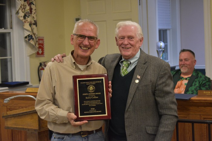 Building Inspector Kerry Collins (L.) received commendation from Mayor Paul Ehrbar (R.) for his dedication.