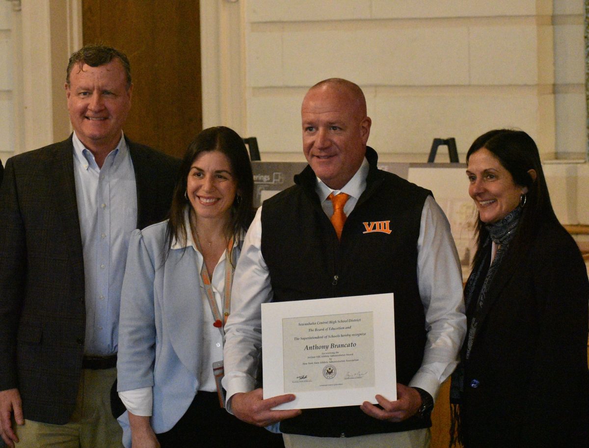 (L. to R.) Board President William Leder, H. Frank Carey High School principal Jennifer Alaimo, H. Frank Carey High School Director of Physical Education Anthony Brancato and Superintendent Regina Agrusa during awards presentations.