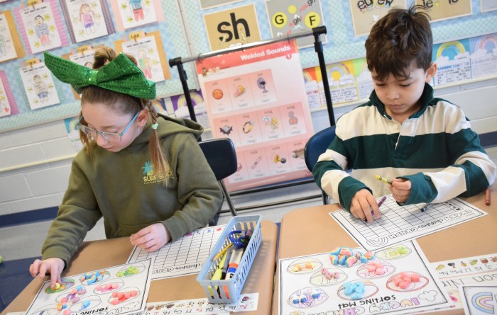 First graders Brooke McCormick and Jason Nino sorted Lucky Charms marshmallows to make a graph showing how many of each piece they had.
