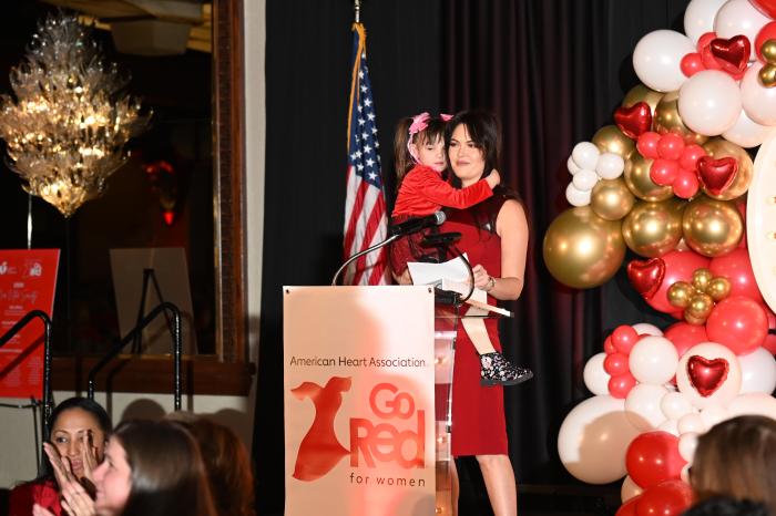 Event chair Hana Boruchov, with her daughter, Adela, delivers remarks at the Long Island Go Red for Women Celebration.