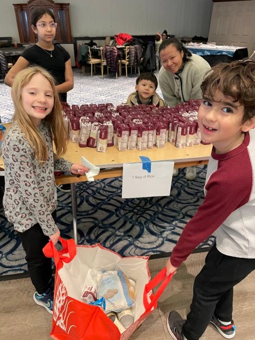 Volunteers packing care packages for people facing food insecurity in Great Neck.