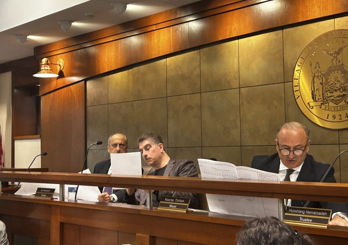 Trustee Ebi Victory, Trustee Ira Nesenoff, and Mayor Kouros Torkan (L. to R.) looking at an applicant's plans to build a pier.