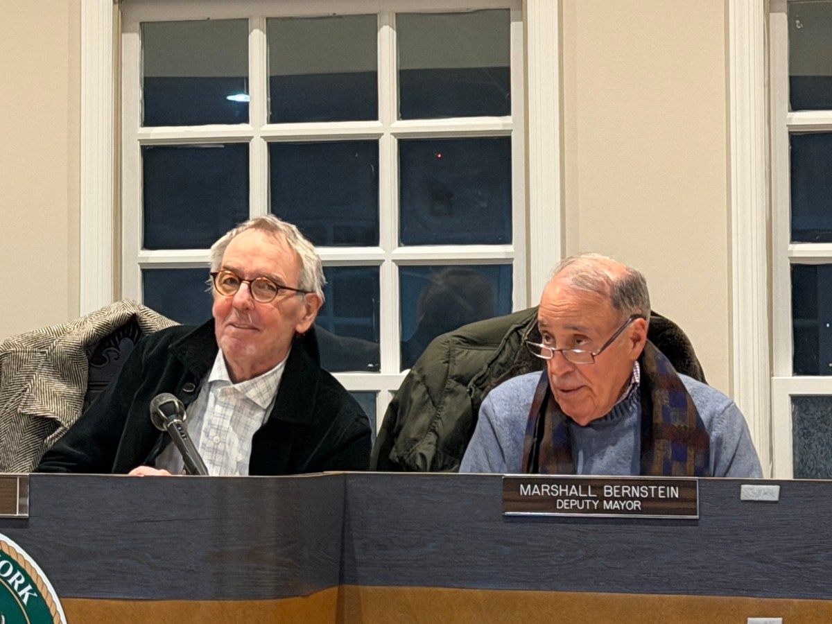 Village of Roslyn Mayor John Durkin (L.) and Deputy Mayor Marshall Bernstein (R.) discussed parking meters during Bernstein's last board of trustees meeting.