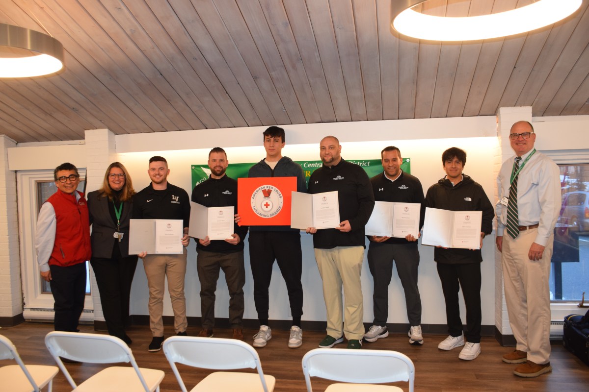 American Red Cross of Long Island CEO, Jose Dominguez (L.) presented coaches Brian Lorusso, Andrew Bock, Andrew Siegel, Ben Martinez and Elliot Aramayo with the organizations Lifesaving Awards for their efforts to resuscitate high school senior Francesco Allocca (C.) during a cardiac event in November.