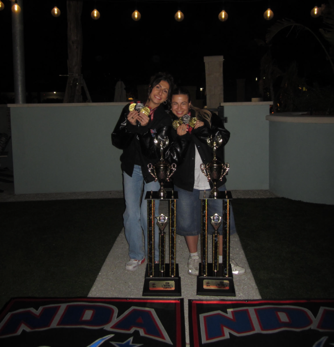 Syosset Varsity Kickline coaches Jennifer Ross (L.) and Alexa Miller (R.) celebrated the victory with their team in Orlando, Florida.