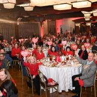 Volunteers and leaders raise their paddles in support of women’s heart health at the 2026 Long Island Go Red for Women Celebration.