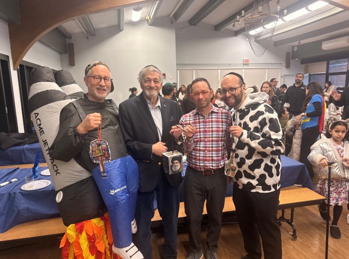 Dr. Paul Brody (2nd from left), initiator of the eponymous NSHA Middle School Megillah Readers Program, is flanked by (at left) Rabbi Dr. Jeffrey Kobrin, NSHA Rosh HaYeshiva/Head of School, and Cantor Yitzy Spinner and Rabbi Simon Basalely, who instructed this year’s Megillah readers, along with Rabbi Adam Acobas (not shown).