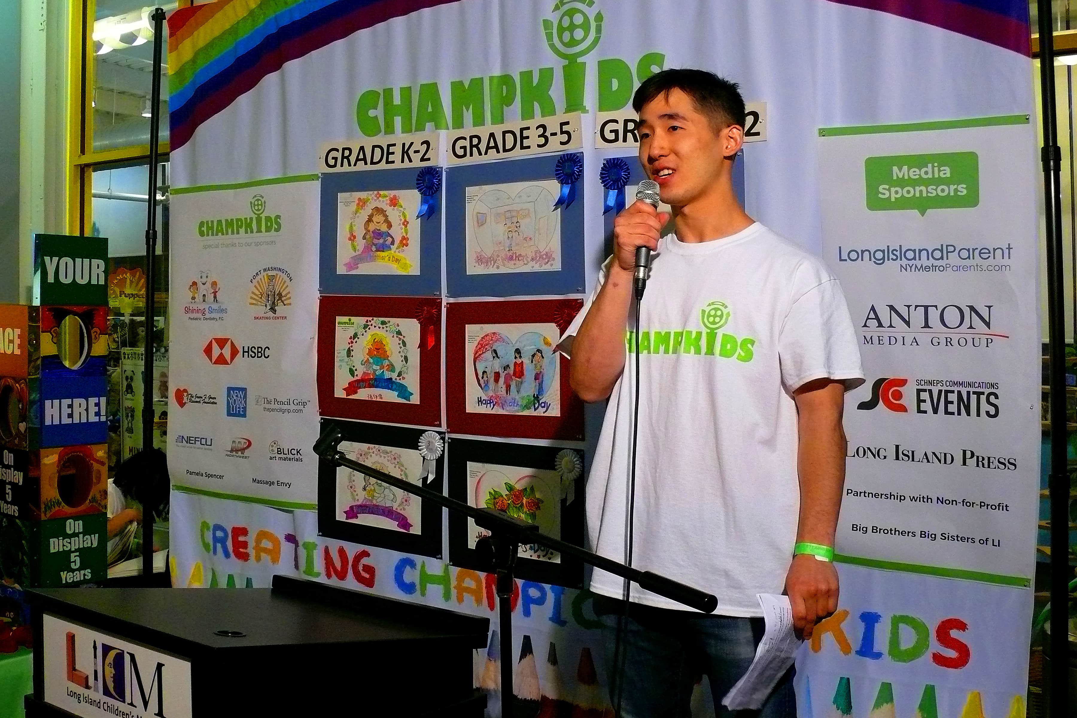 M.C. for the awards presentation and coordinator for the Saturday night program for Champskids, Daniel Lee, gathers att the participants to start the awards portion of the night's program.