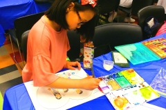 Kexin Su creates free form art concepts for consideration for prizes withthe Champkids competition at the Children's Museum on Saturday night (Photo by Joe Abate).
